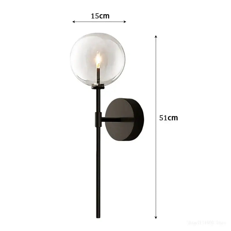 Black metal wall sconce with a clear glass ball shade designed for retro gold living room lighting