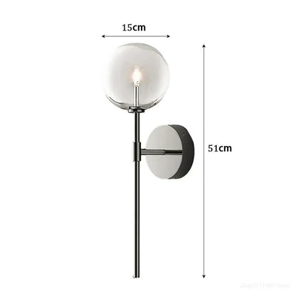 Modern wall sconce with a clear glass ball globe, sleek black metal frame, and mounting plate for living room lighting
