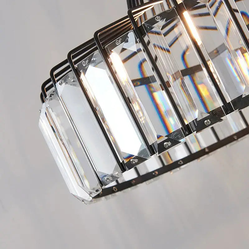 A modern black metal frame pendant light with clear faceted crystal prisms decorbites crystal led pendant for dining room