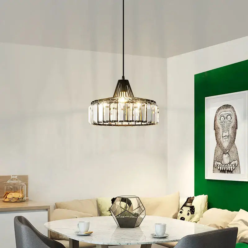 A modern geometric decorbites crystal led pendant light with black metal frame and clear crystals for dining room