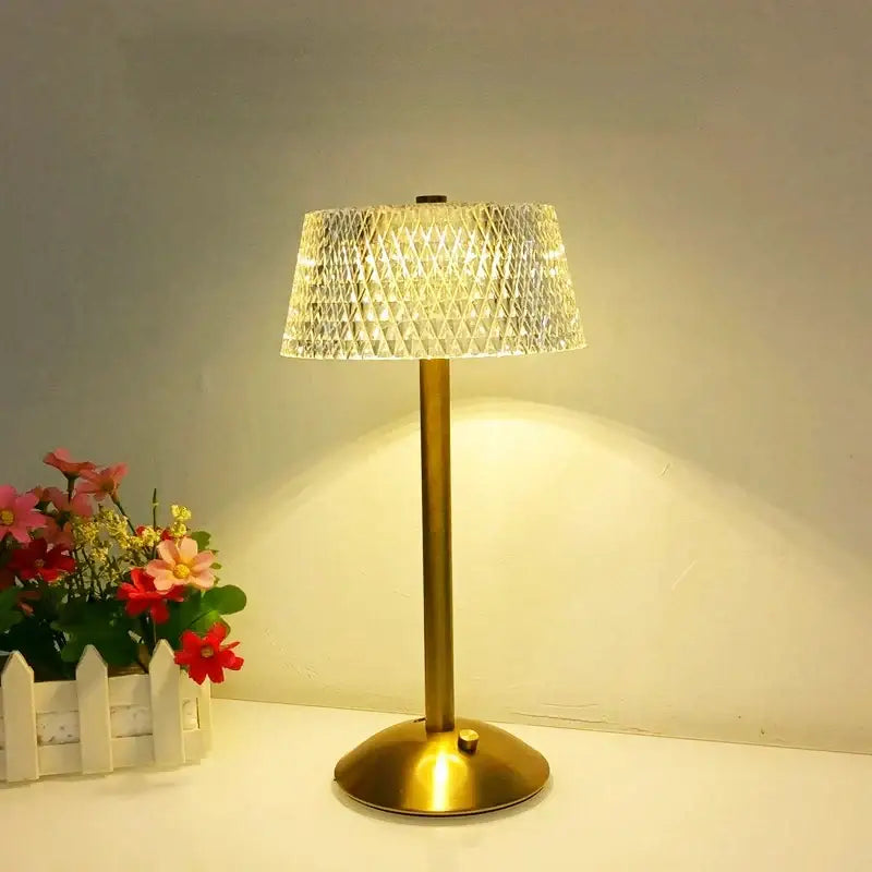 A warm-toned brass retro gold diamond crystal table lamp with a translucent geometric shade for bedroom night light