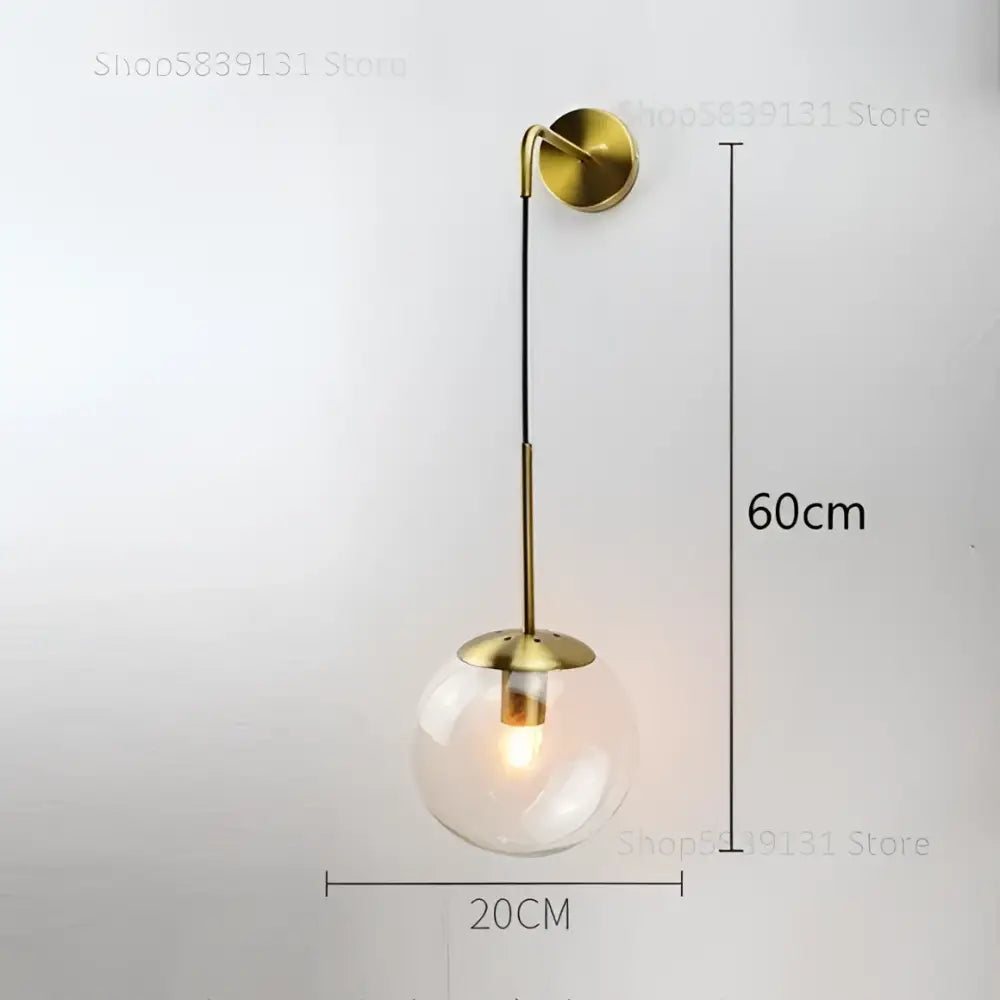 Brass-finished retro gold decorbites glass ball wall lamp with clear glass globe and illuminated bulb for bedroom decor