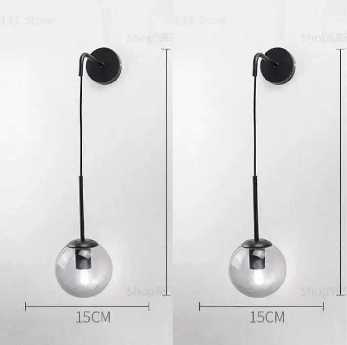 Modern black metal wall lamp with a clear glass ball shade perfect for decorbites glass ball wall lighting