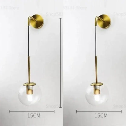 Retro gold glass ball wall lamp with gold-toned brass stem and clear glass globe for bedroom decorbites glass ball sconce