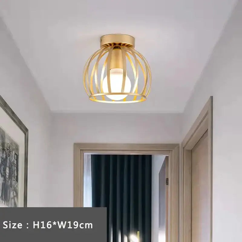 Retro gold iron cage ceiling lamp with warm glowing bulb and intricate wireframe design for bedroom lighting decorbites iron cage