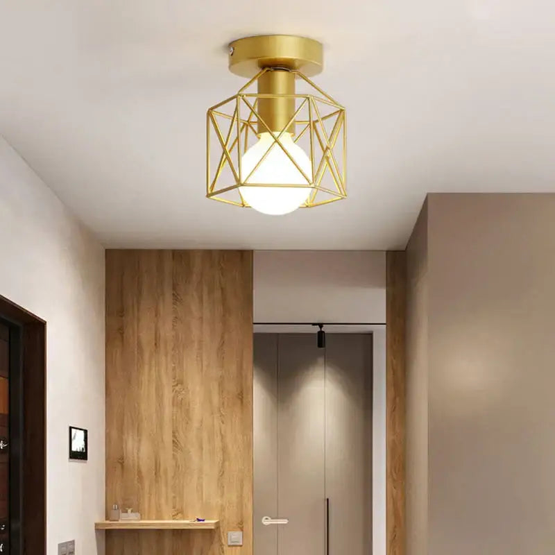 Gold geometric ceiling lamp with decorbites iron cage and frosted glass bulb for warm bedroom lighting