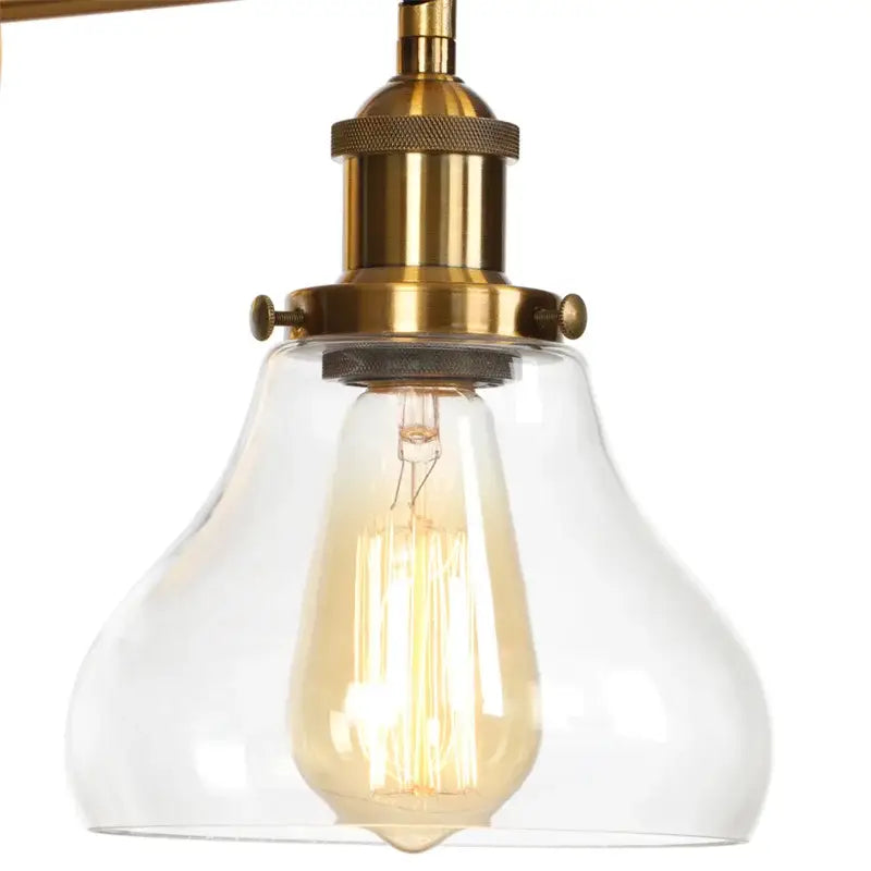 A vintage-style retro gold led wall sconce with a brass finish and clear glass shade for bedroom decorbites gold led lighting