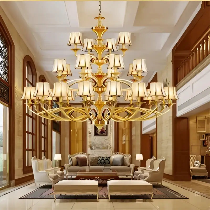 Golden ornate decorbites copper villa chandelier with multiple tiers of cream lampshades for staircase decor