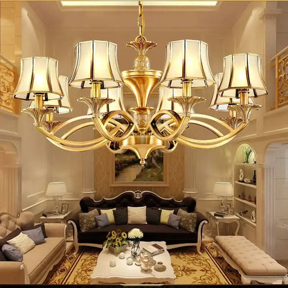 Gold-toned decorbites copper villa chandelier with ornate curved arms and cream lampshades for villa staircase decor