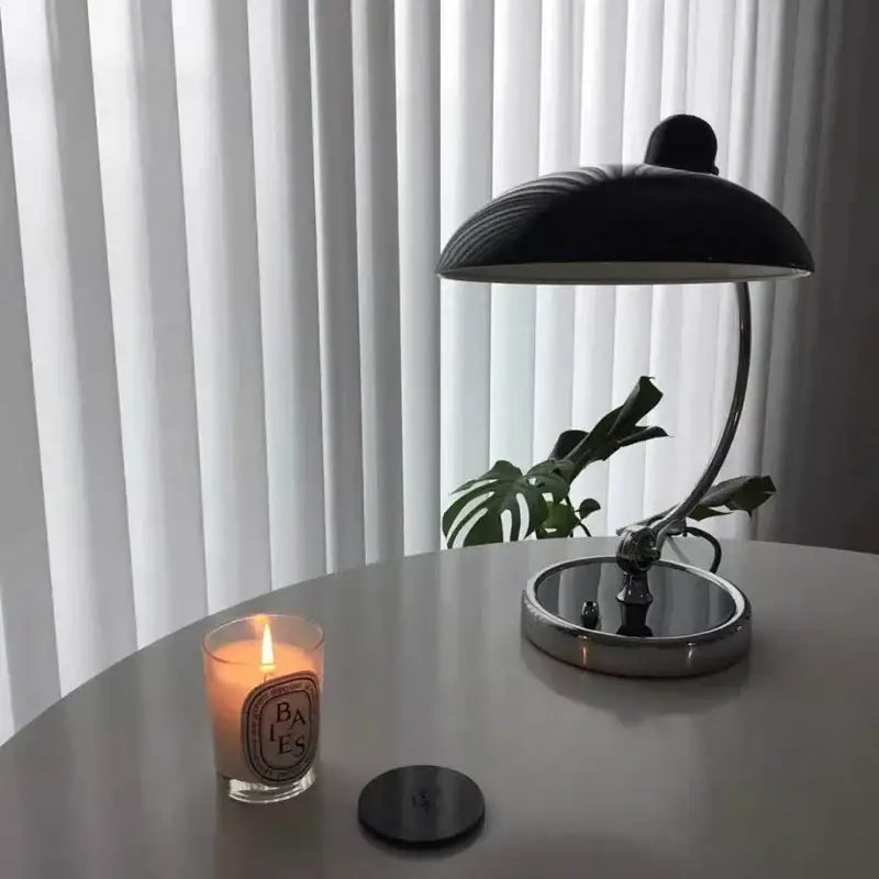 Black dome-shaped engraving table lamp with chrome base and curved metal arm for office or bedroom use
