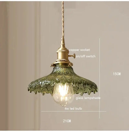 Retro green glass pendant light with wood accent featuring vintage brass hardware and twisted copper cord for dining room use
