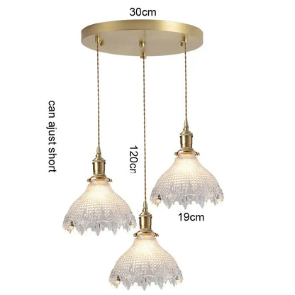 Brass-finished three-light pendant light with wood accent and textured glass shades for dining room with e27 led bulb