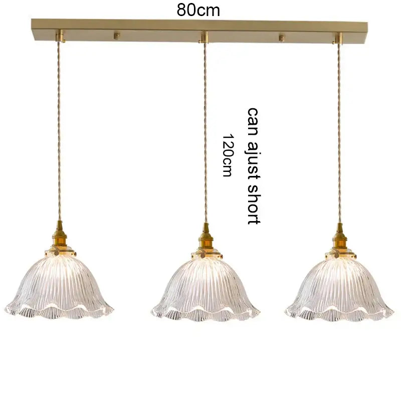 Gold-toned three-light pendant light with clear ribbed glass shades and wood accent for dining room with e27 led bulb compatibility