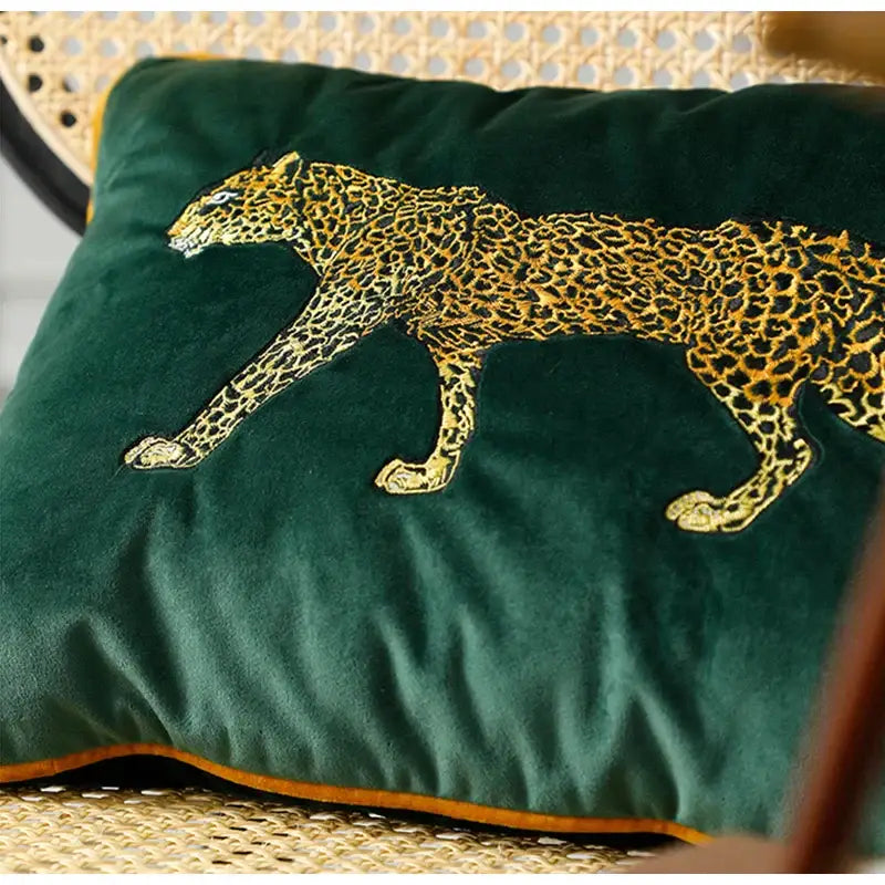 Deep green velvet embroidered leopard cushion cover featuring a golden leopard in a walking pose for living room
