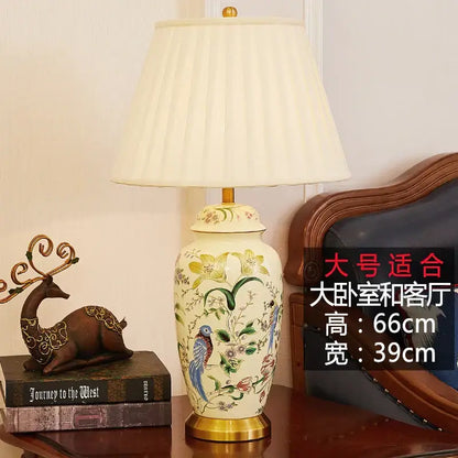 Cream-colored ceramic table lamp with hand-painted decorbites country flower bird motifs and gold-toned base for bedroom decor