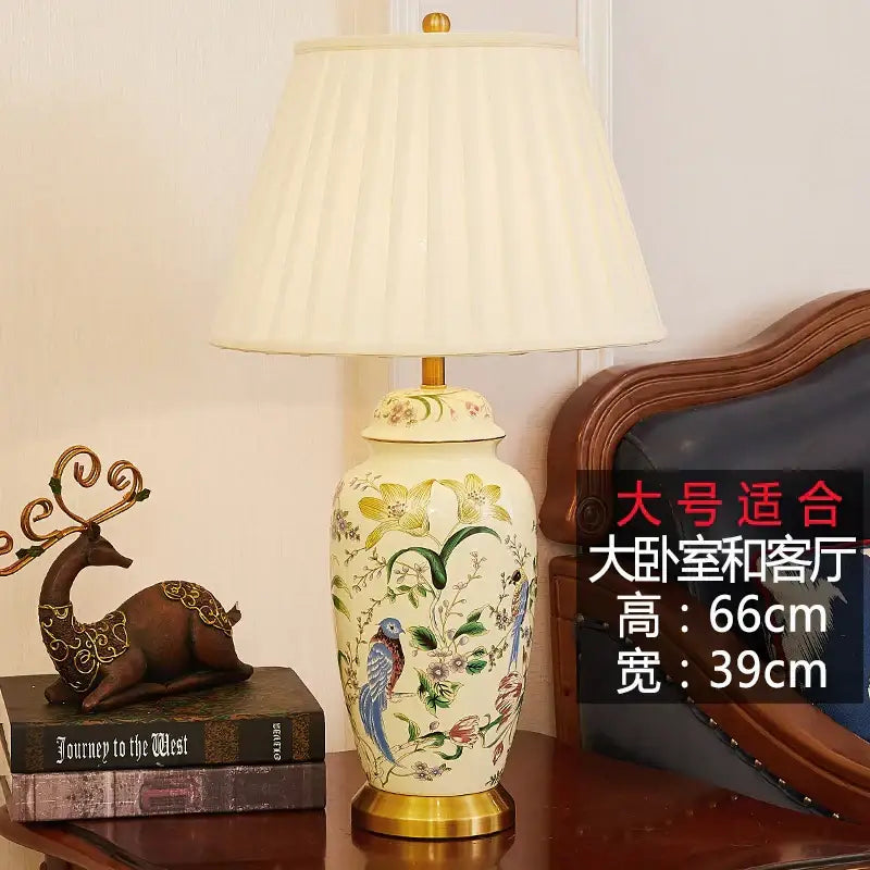 Cream-colored ceramic table lamp with hand-painted decorbites country flower bird motifs and gold-toned base for bedroom decor