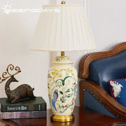 Cream-colored ceramic table lamp with hand-painted country flower bird motifs and gold-toned metal base for bedroom decorbites country flower decor