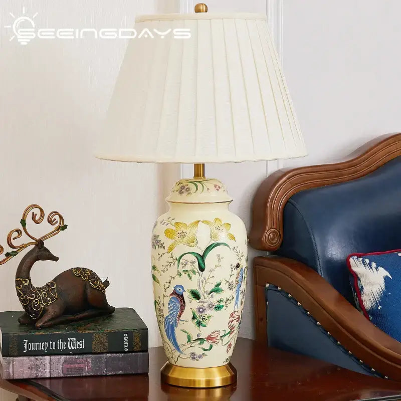 Cream-colored ceramic table lamp with hand-painted country flower bird motifs and gold-toned metal base for bedroom decorbites country flower decor