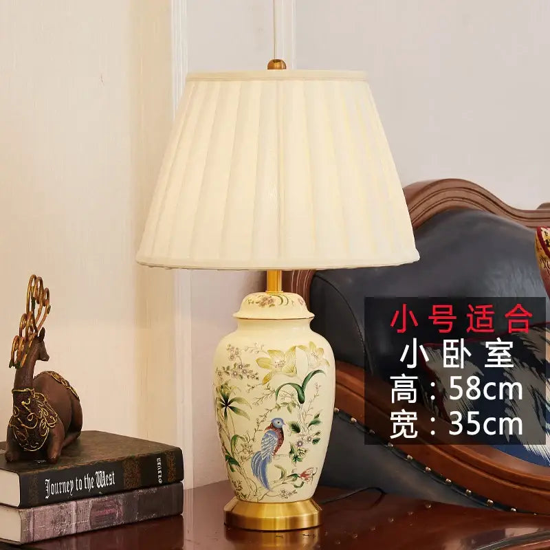 Cream-colored ceramic table lamp with hand-painted country flower bird motifs and gold-toned base for decorbites decor