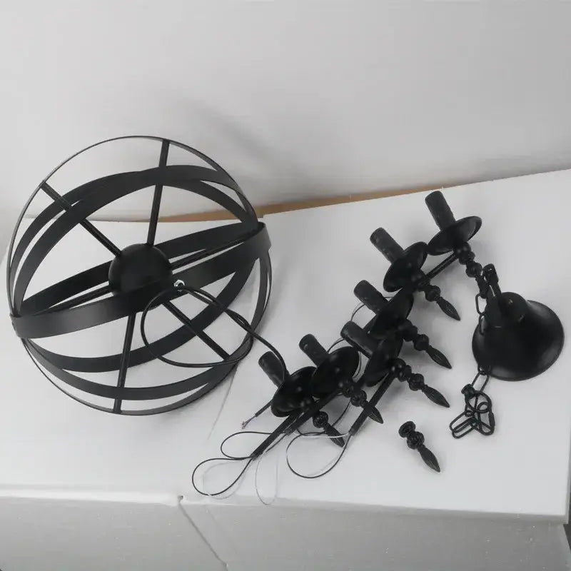 Black metal spherical decorbites iron chandelier with candle-style lights hanging by chains for dining room use