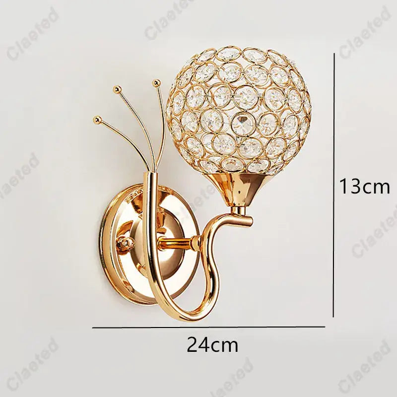 Gold-toned retro industrial wall lamp sconce with spherical crystal globe design for bedroom lighting