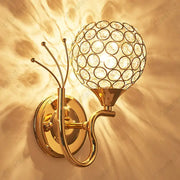 Gold-toned retro industrial wall lamp sconce with spherical crystal globe design for bedroom lighting