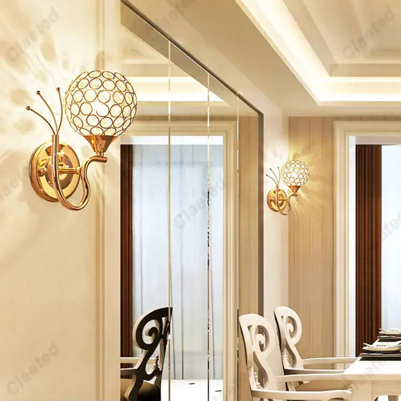 Gold-toned retro industrial wall lamp sconce with spherical crystal globe design for bedroom lighting