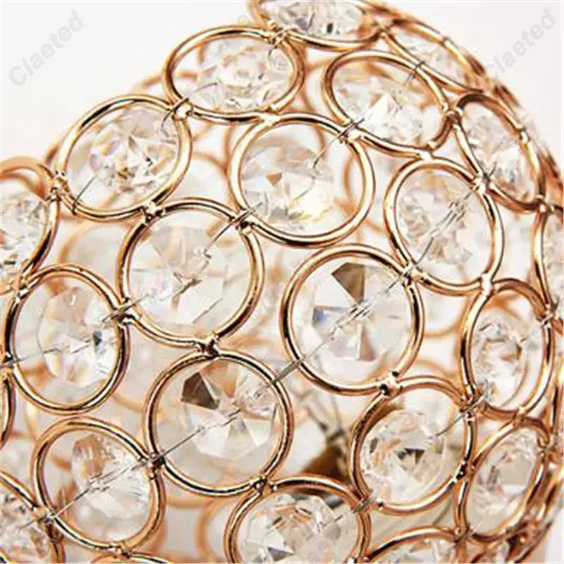 Retro industrial gold wall lamp sconce featuring a sparkling gold-toned crystal orb with clear rhinestones