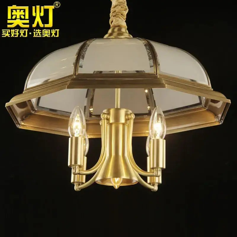 Retro iron bronze pendant light featuring a gold-toned brass chandelier with domed glass shade and three filament bulbs
