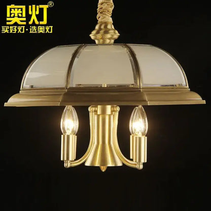 Retro iron bronze pendant light featuring a gold-toned brass chandelier with domed glass shade and three filament bulbs