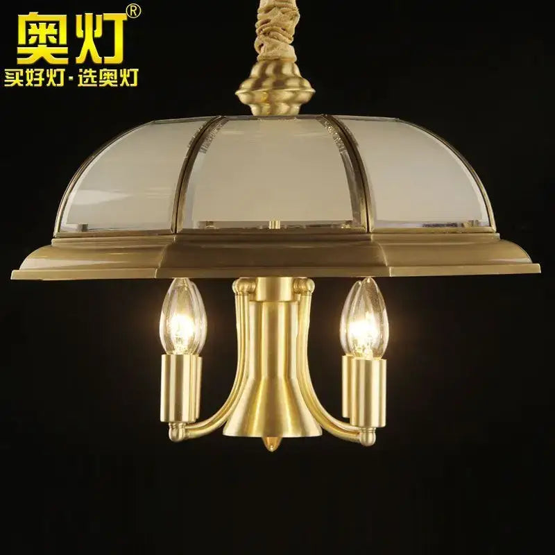 Retro iron bronze pendant light featuring a gold-toned brass chandelier with domed glass shade and three filament bulbs