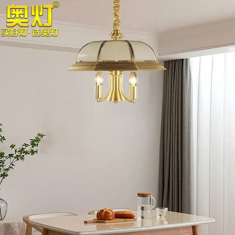 Gold-toned brass retro iron bronze pendant light with domed glass shade and three candle-style bulbs for living room decorbites iron bronze