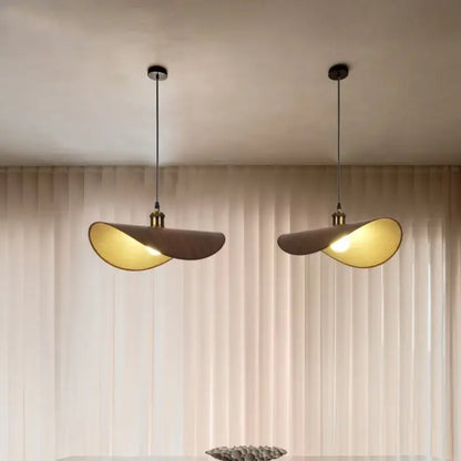Two modern pendant lights with curved beige fabric shades and brass accents for dining room hat pendant light decorbites