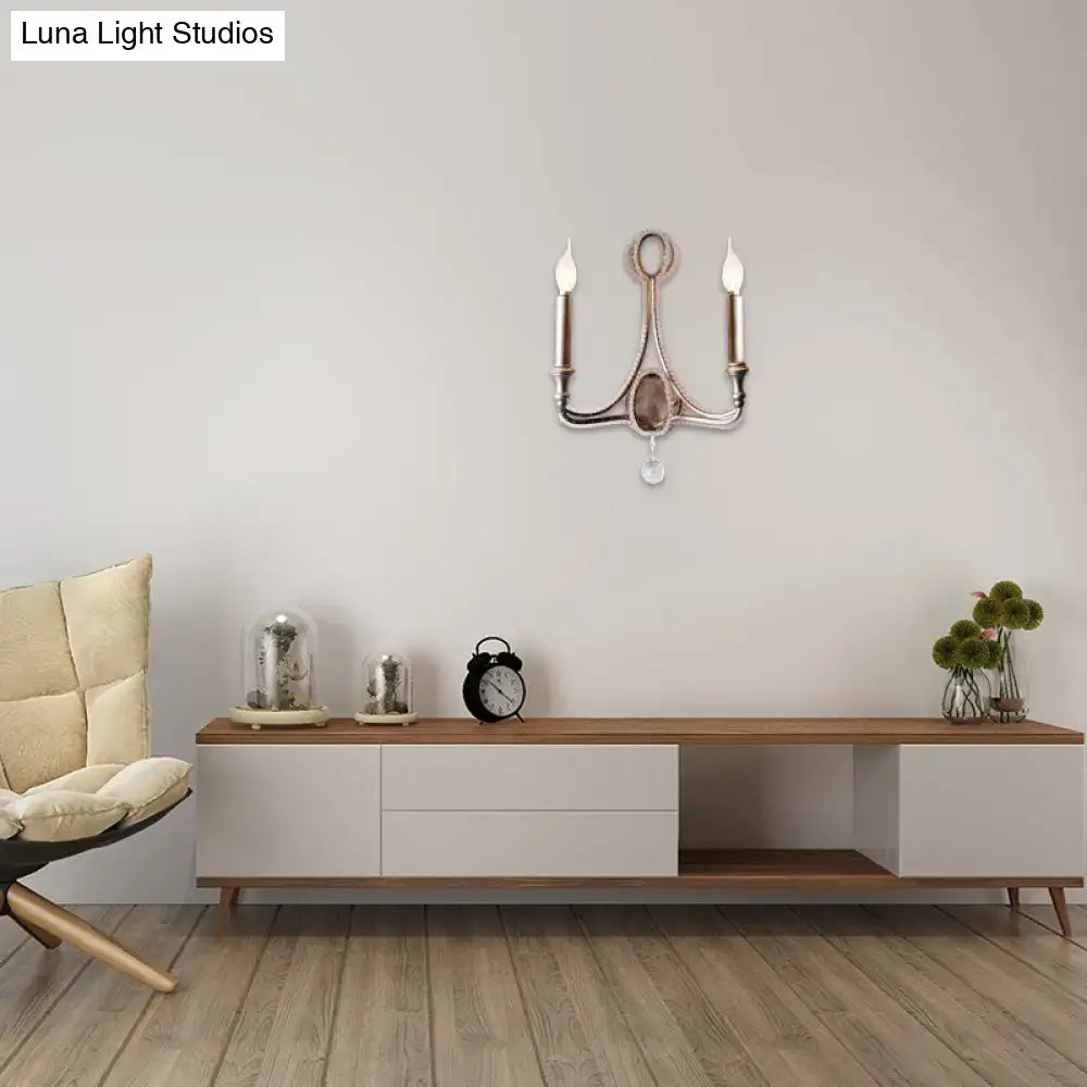Antique silver-toned aged silver wall light with two candle bulbs and central oval mirror for retro loft fabric decor