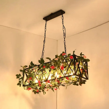 Decorbites™ black retro metal pendant light with geometric design, artificial vines, pink roses, and warm glowing lights
