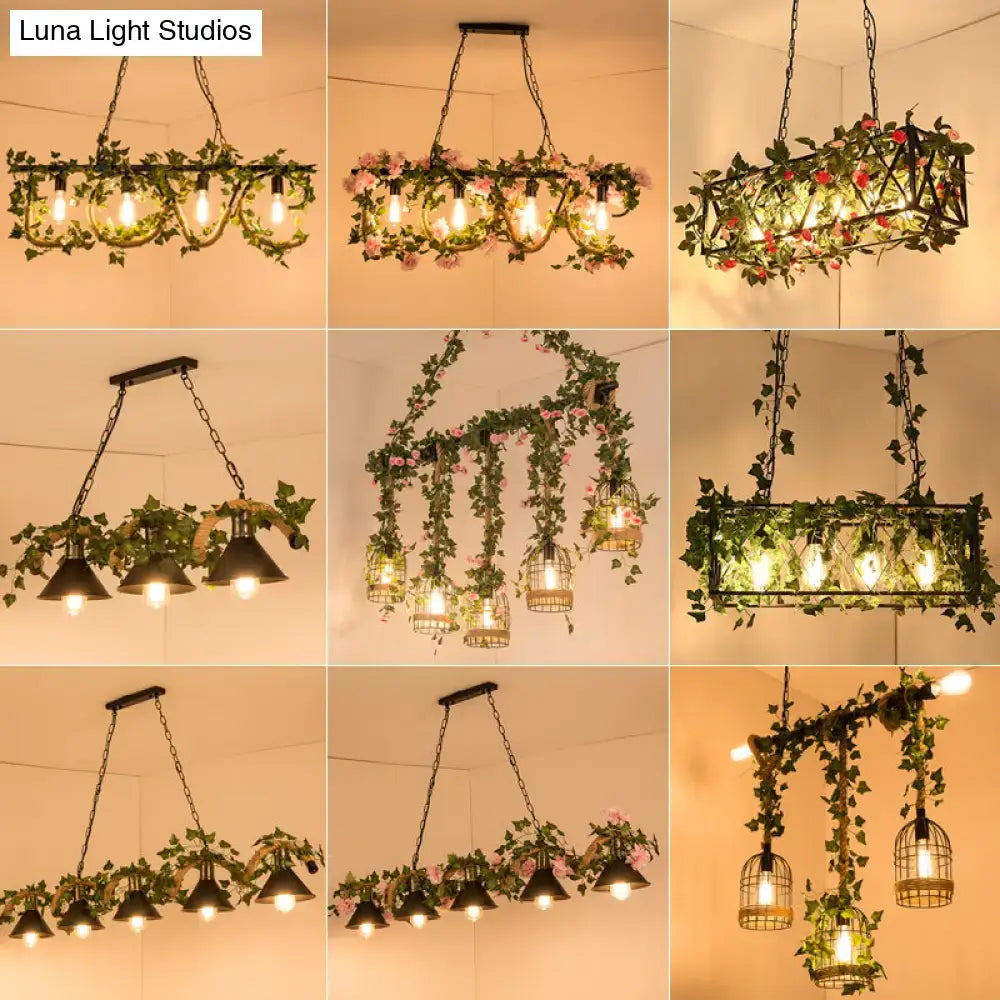 Rustic black retro metal pendant light with cage-style design and artificial green vines featuring warm glowing bulbs