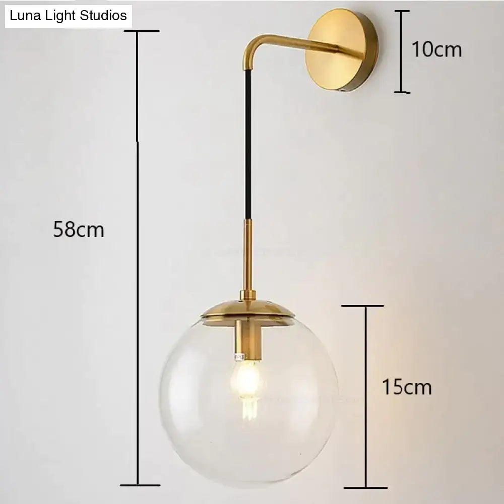 Gold-finished retro modern glass wall lamps with clear smoked globe and black accent rod for bedroom lighting