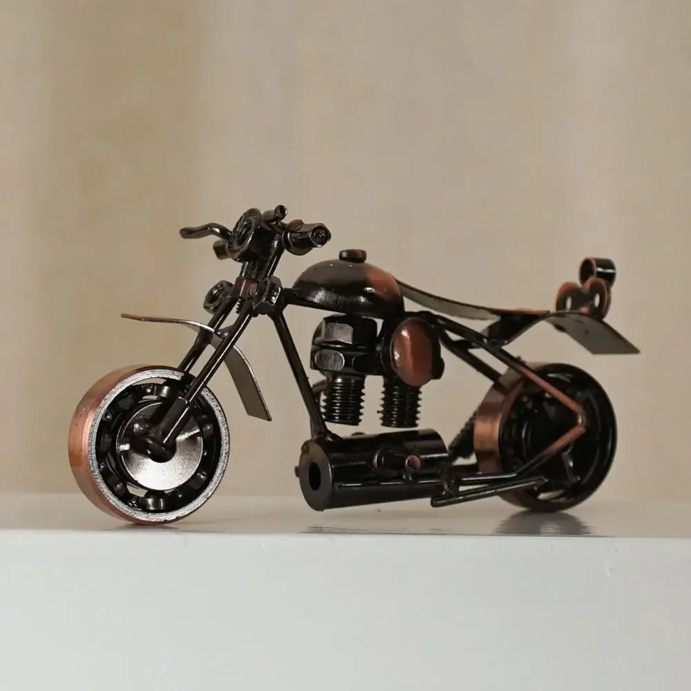 Black and copper-colored metal figurine of retro motorcycle model crafted from repurposed parts for living room decor