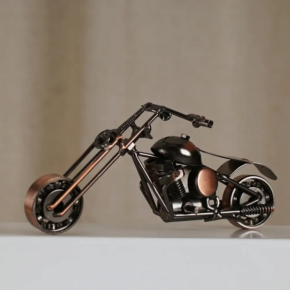 A rustic copper and black metal retro motorcycle model figurine crafted from repurposed industrial parts for decor