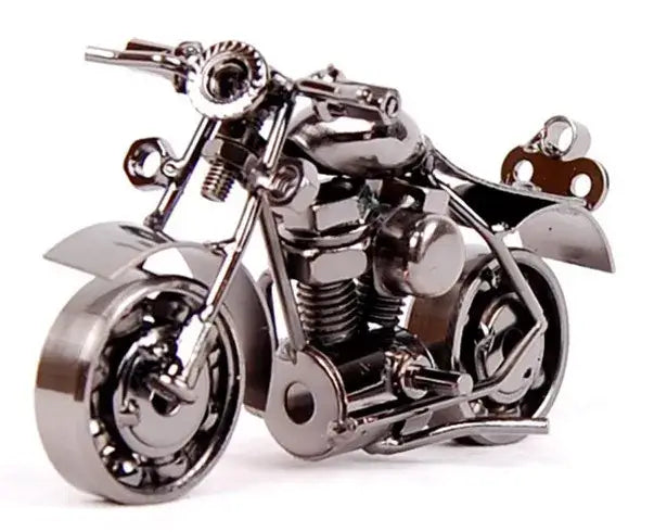 Shiny chrome metal figurine of a retro motorcycle model crafted from repurposed mechanical parts for living room decor