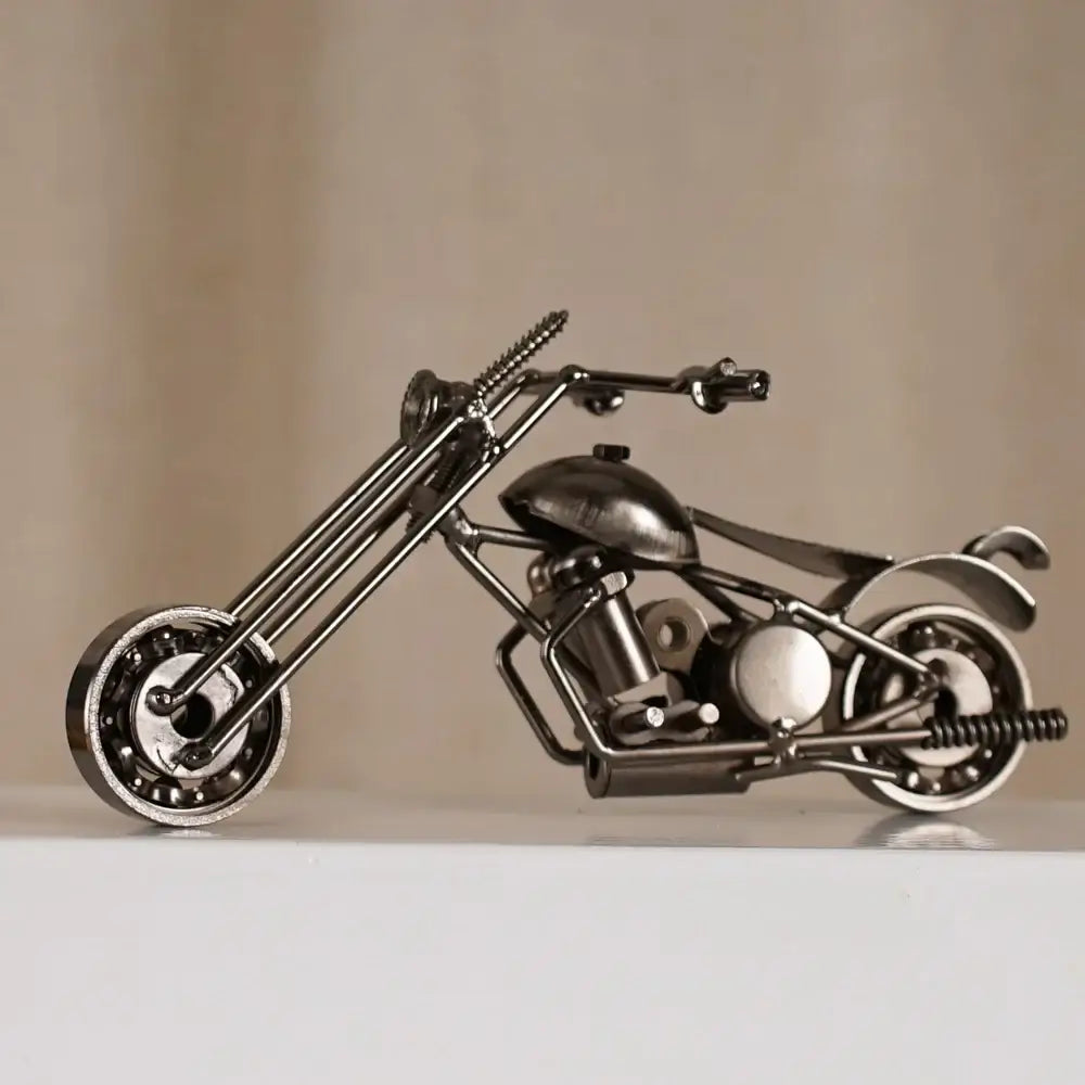 A sleek metallic retro motorcycle model metal figurine crafted from repurposed metal parts for living room decor