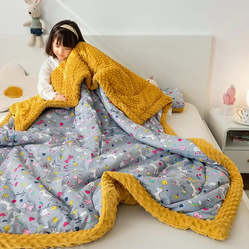 Retro mustard lion cotton floral double quilt with a yellow textured fleece side and gray bunny candy patterned back
