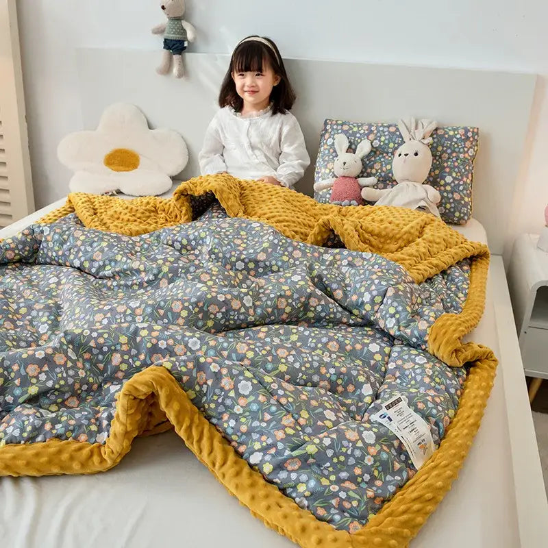 Cozy cotton floral double quilt with soft gray floral pattern and vibrant mustard-yellow textured border for bedroom bedding