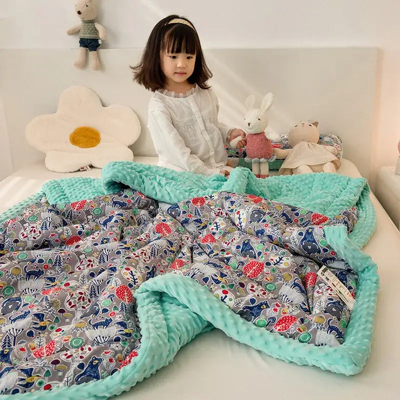 A cozy mint green cotton floral double quilt with playful gray animal patterns and soft textured edging for bedding