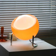 Retro orange glass table lamp with glowing spherical glass shade and sleek chrome stand for bedroom night light decorbites glass table