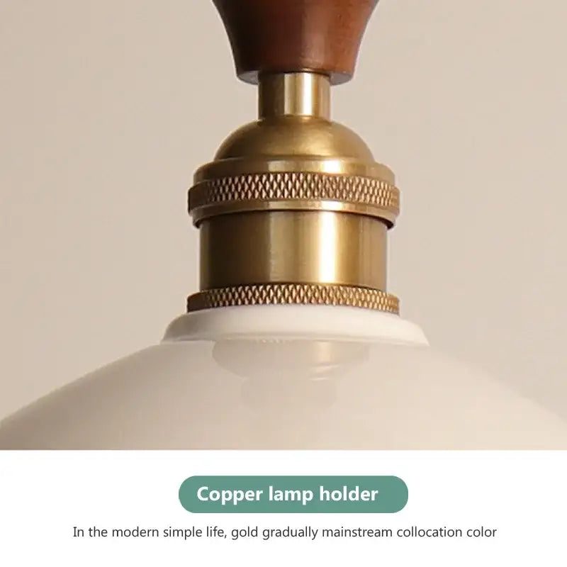 Brass-finished copper lamp holder with a wooden top and textured metallic bands.