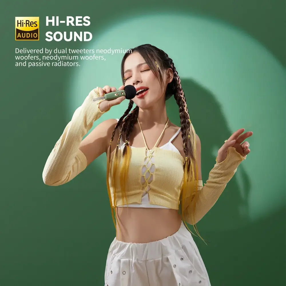 Green handheld microphone with black grille and silver accents for retro pink bluetooth speaker with karaoke sound modes