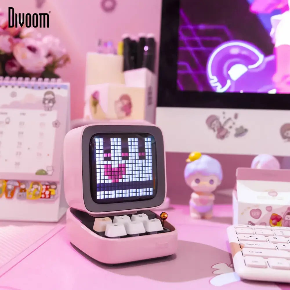 Retro pink dilo pixel art bluetooth speaker shaped like a computer with a heart on its pixel art game screen
