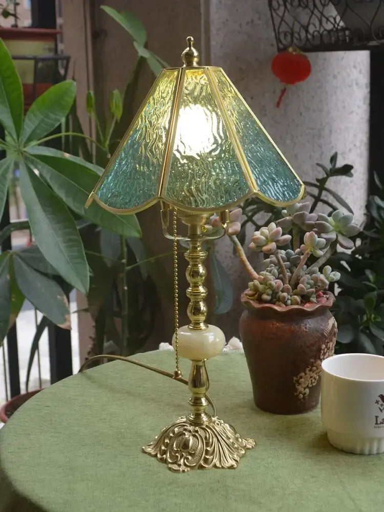 Antique-style brass desk lamp with textured green glass shade and ornate base for vintage bedroom decorbites brass desk lamp