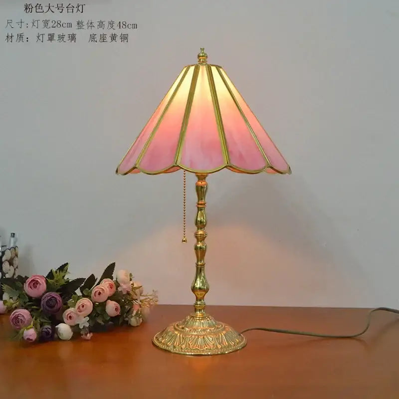 Retro pink stained glass brass desk lamp with gold trim on ornate base casting warm glow for vintage decorbites brass desk lamp